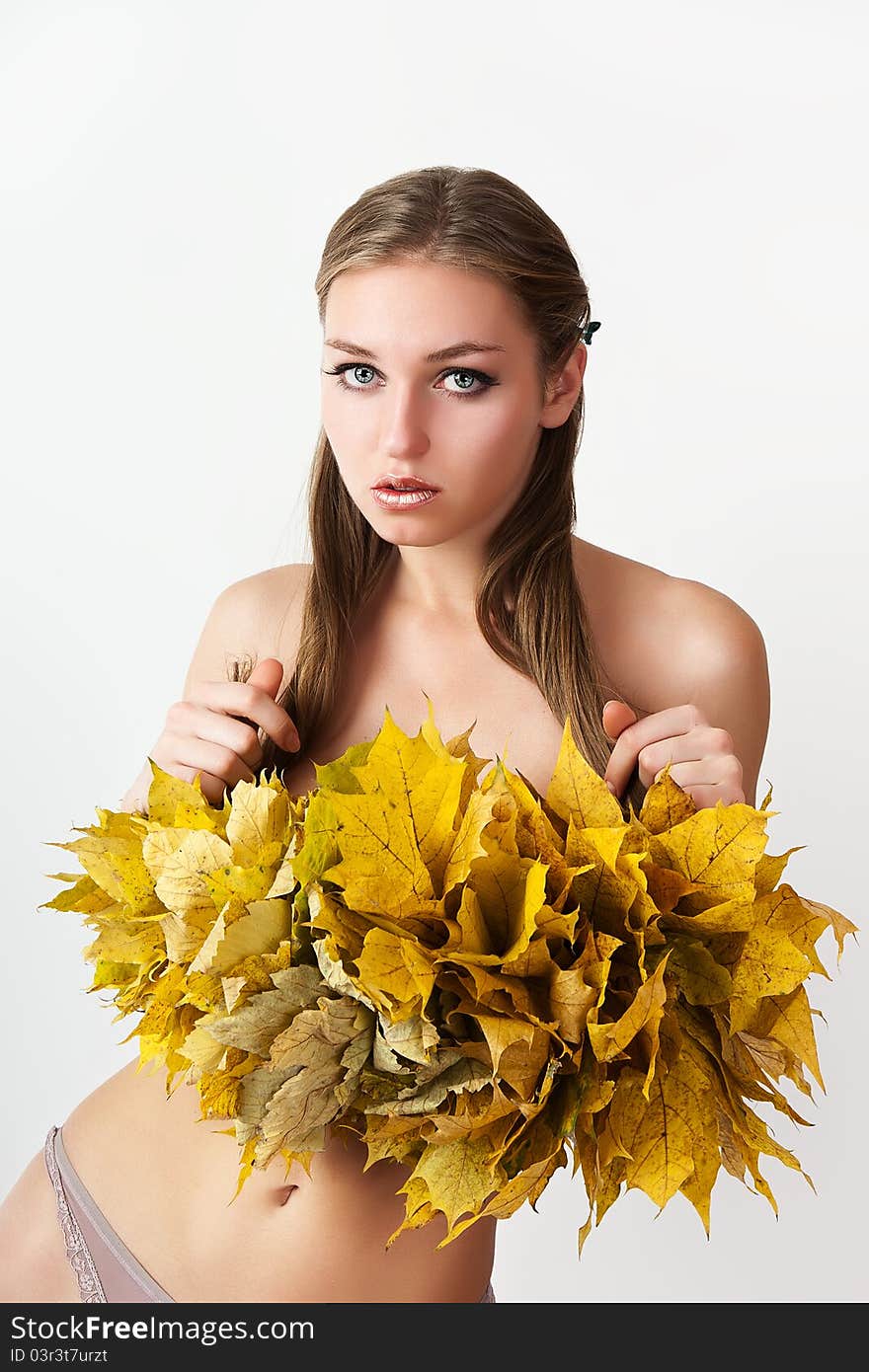 A girl with a wreath of autumn leaves. A girl with a wreath of autumn leaves.