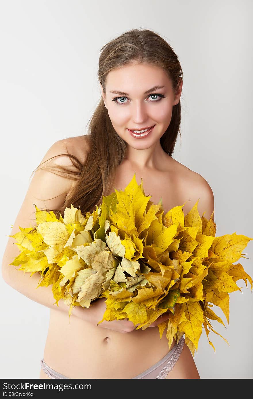 A girl with a wreath of autumn leaves. A girl with a wreath of autumn leaves.