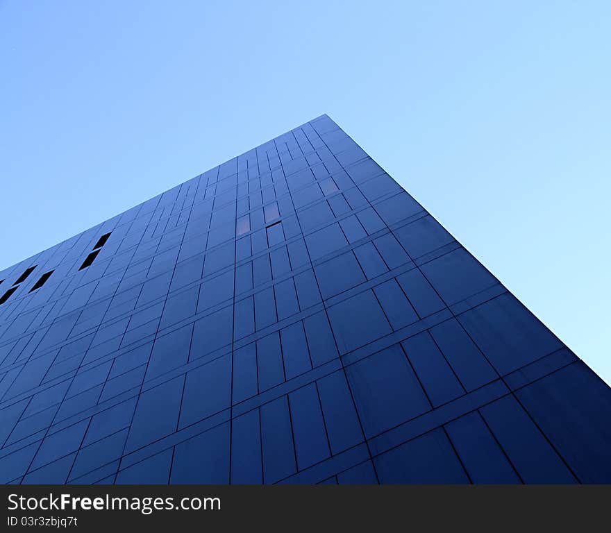 An upwards view of a fresh clean business office block in the day. An upwards view of a fresh clean business office block in the day