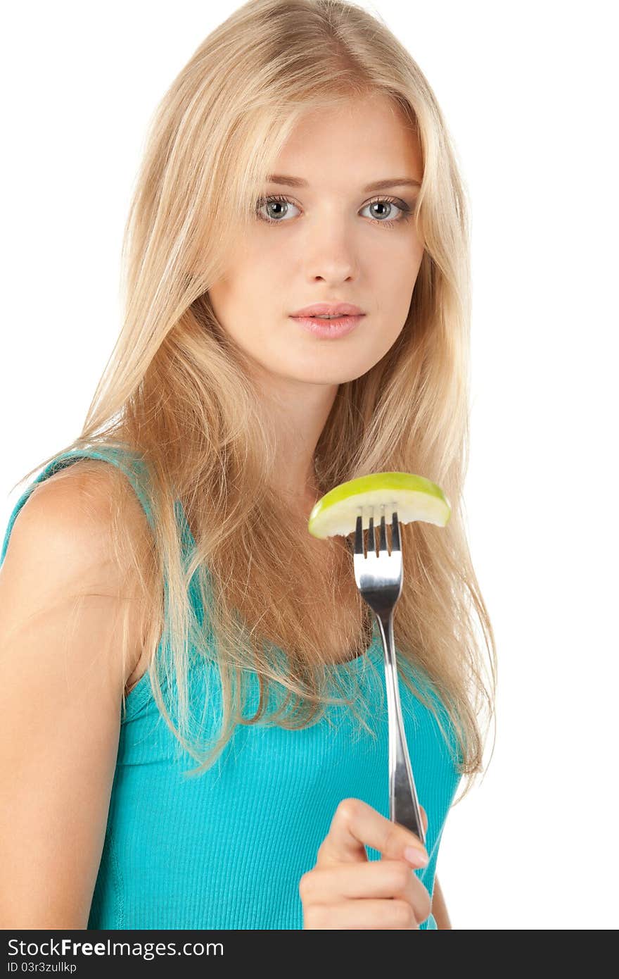 Beautiful blond female holding a piece of green apple on the fork over white background. Beautiful blond female holding a piece of green apple on the fork over white background