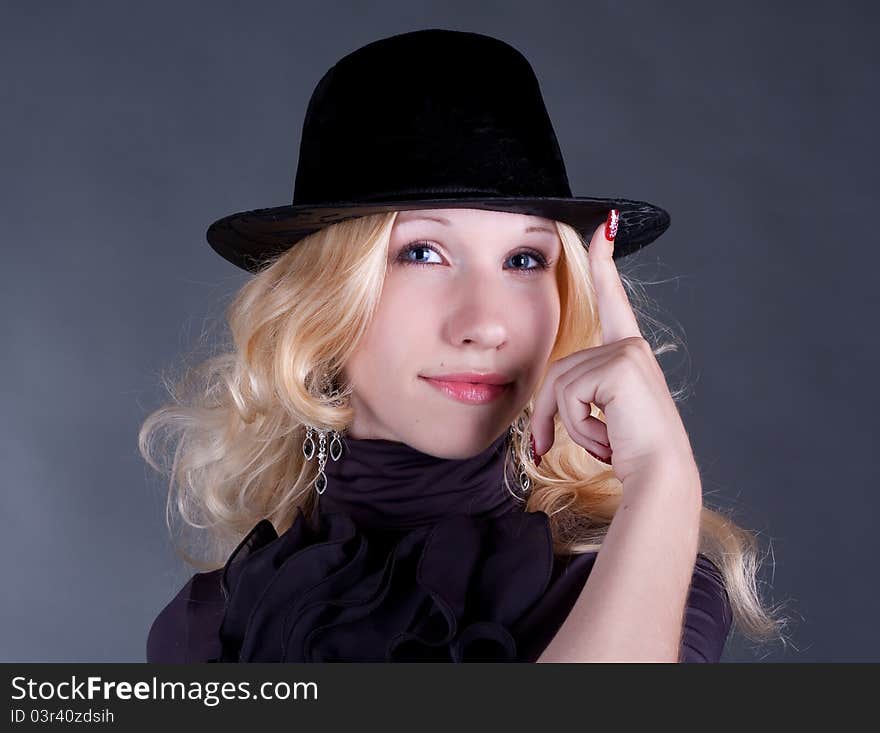 portrait of a beautiful young blonde woman in hat