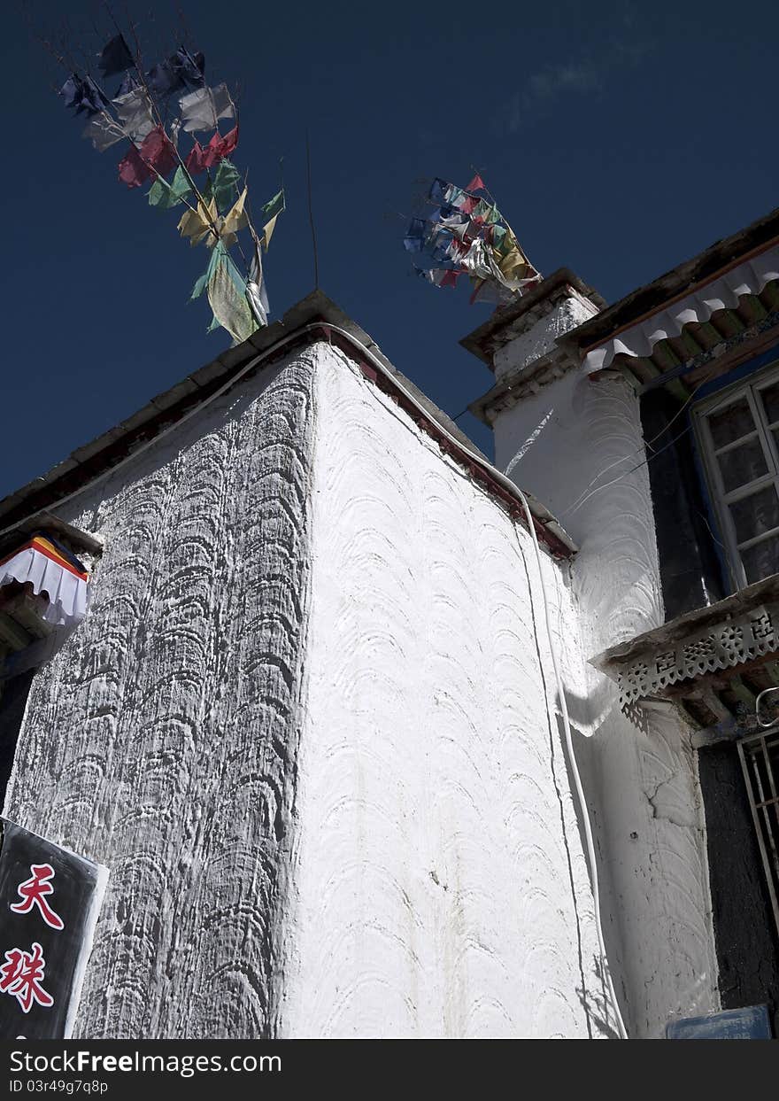 Wall of Tibetan house and five color flag