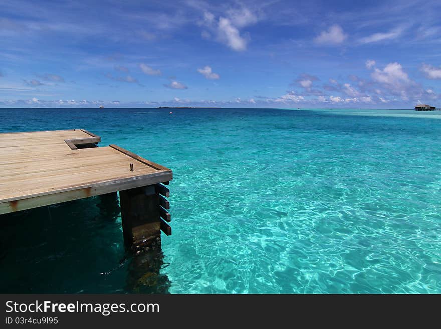 Deck and pier of blue tropical sea, Maldives