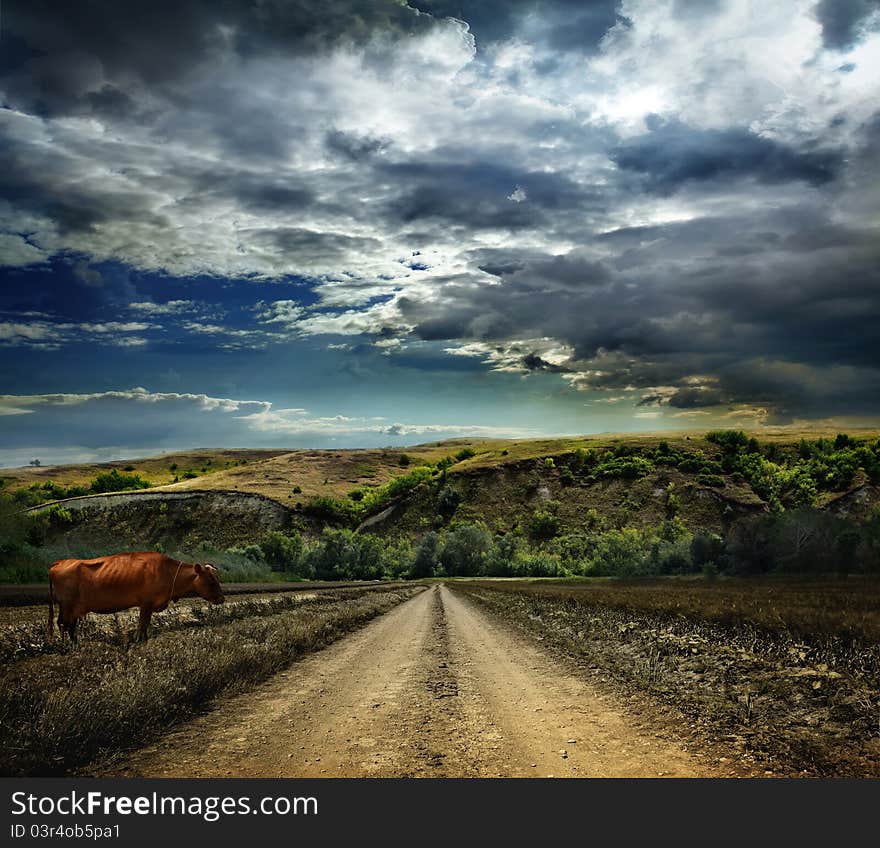 Landscape with dirt road in the mountains under cloudy sky. Landscape with dirt road in the mountains under cloudy sky