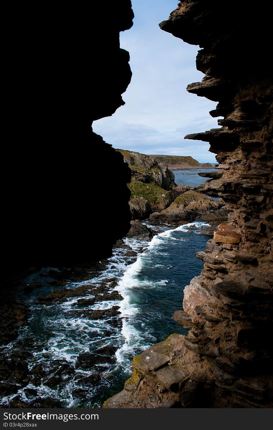 Atlantic Ocean taken through split in falling down castle on the north coast of Scotland. Atlantic Ocean taken through split in falling down castle on the north coast of Scotland