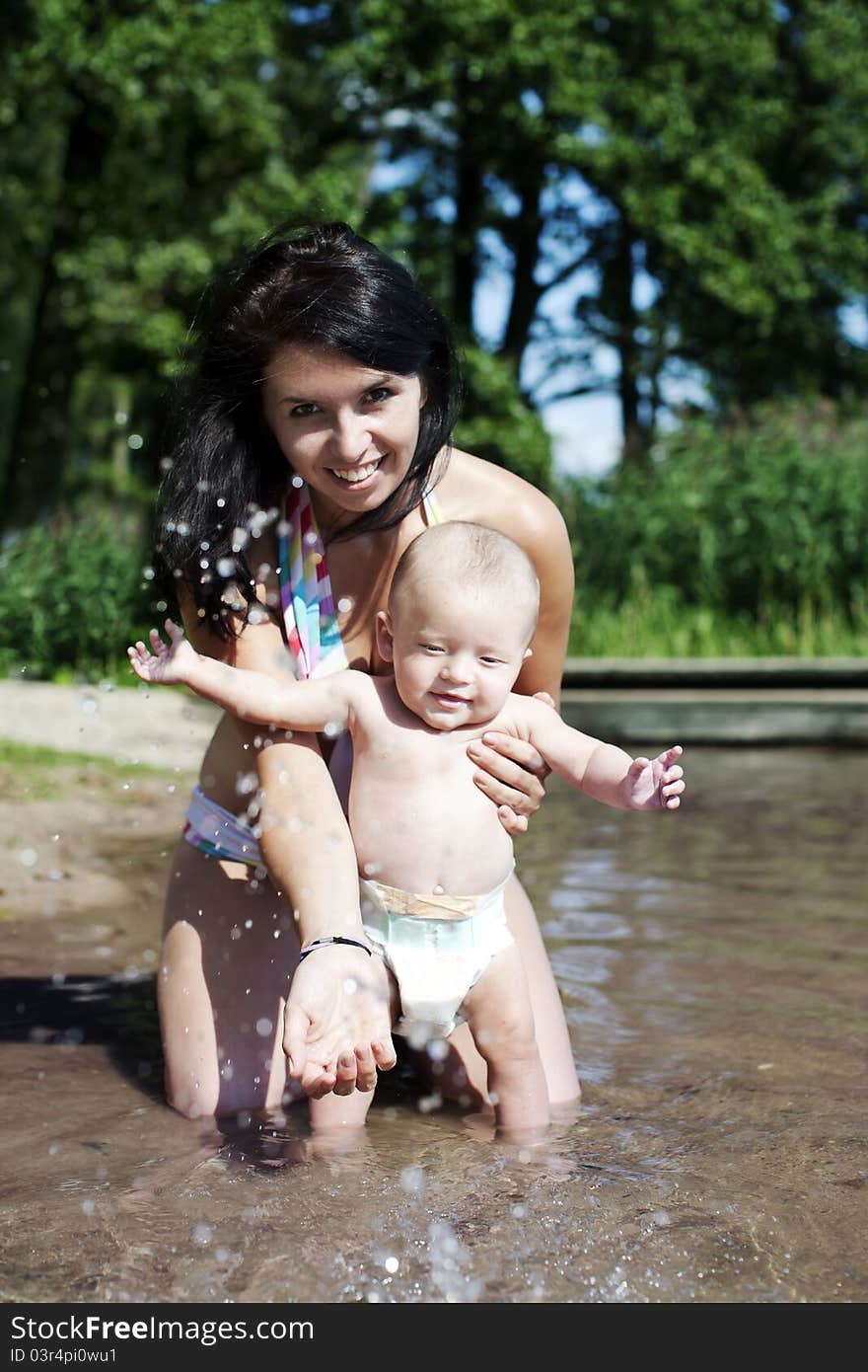 Little girl splashing water while the sun goes down. Little girl splashing water while the sun goes down