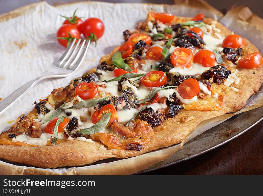 Roasted cherry tomatoes on crispy wholewheat crust. Roasted cherry tomatoes on crispy wholewheat crust