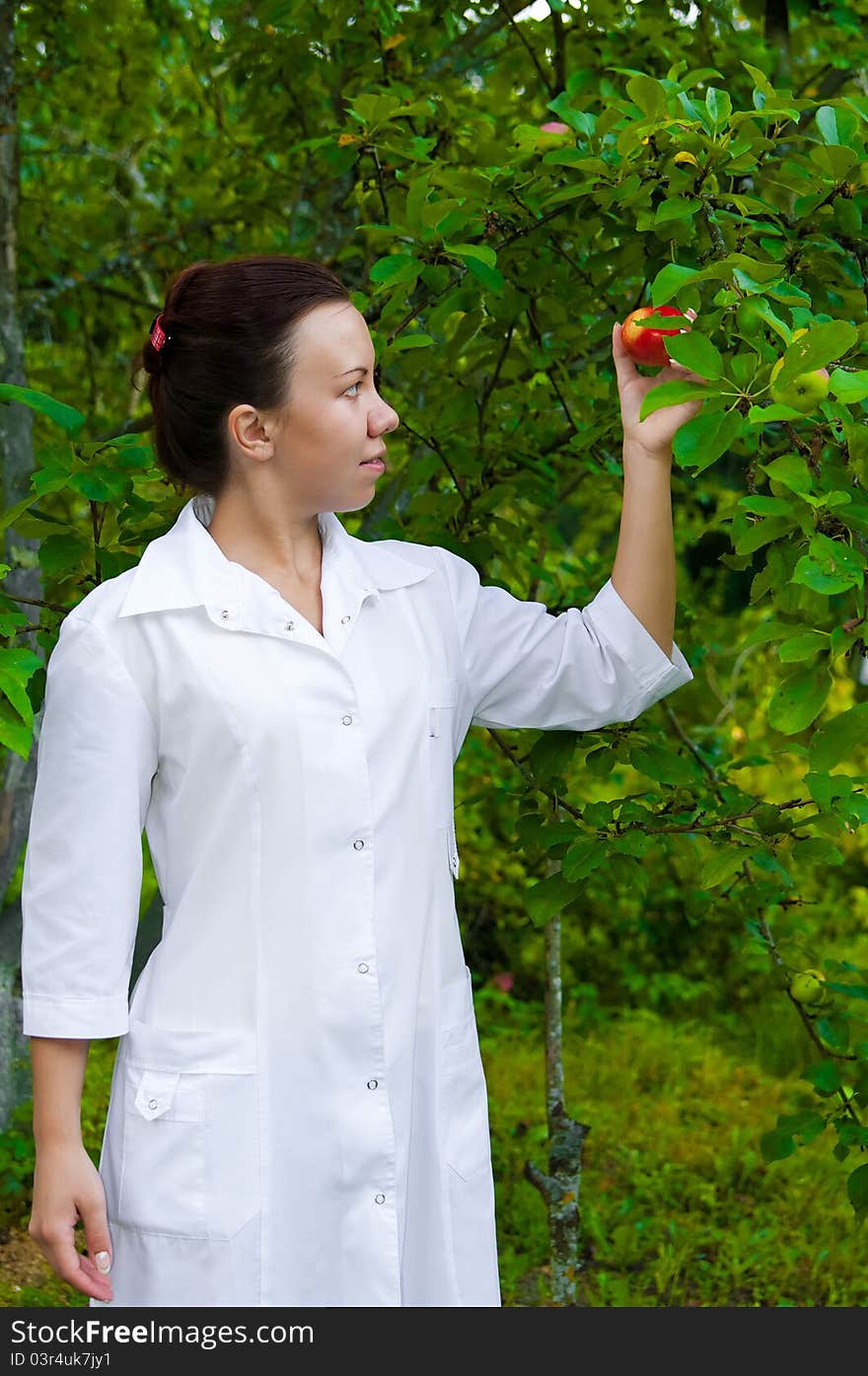 Happy smiling doctor with apple