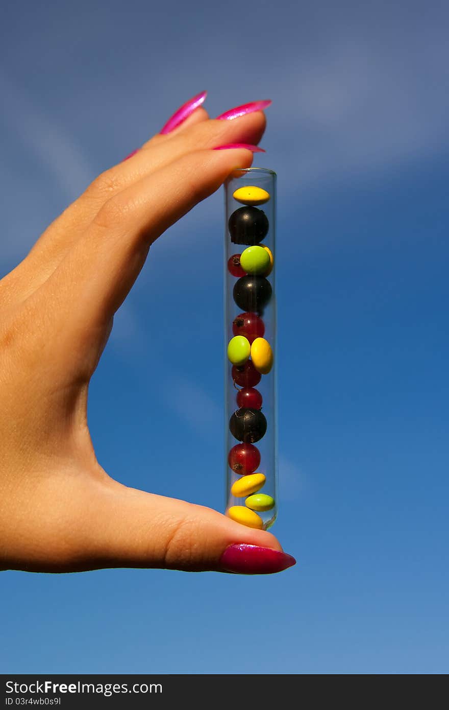 Test tube with tablets, berries and plant