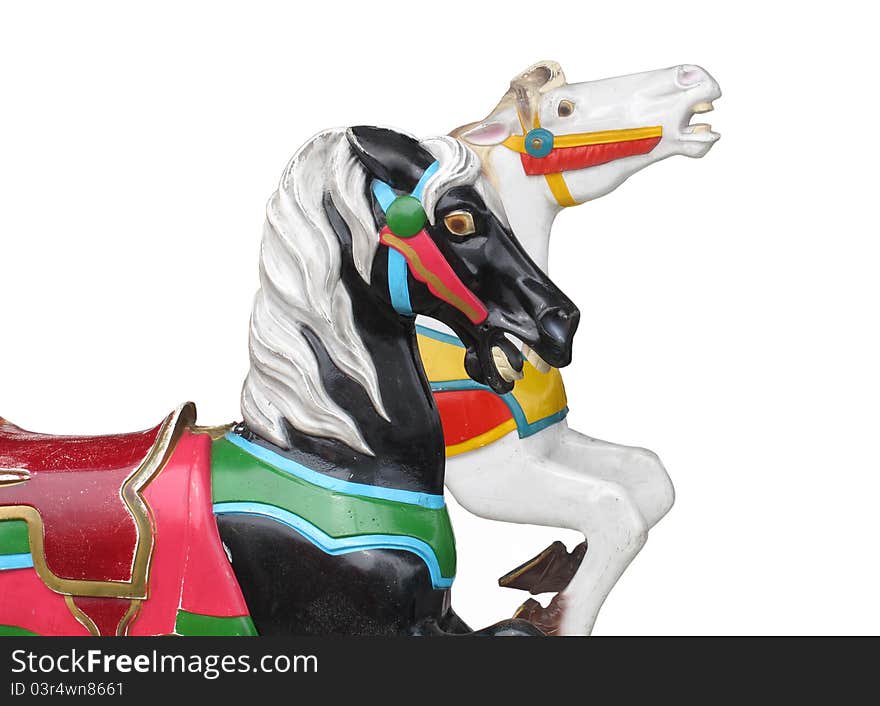 Two vintage carousel horse heads, one black and one white. Isolated on white. Two vintage carousel horse heads, one black and one white. Isolated on white.