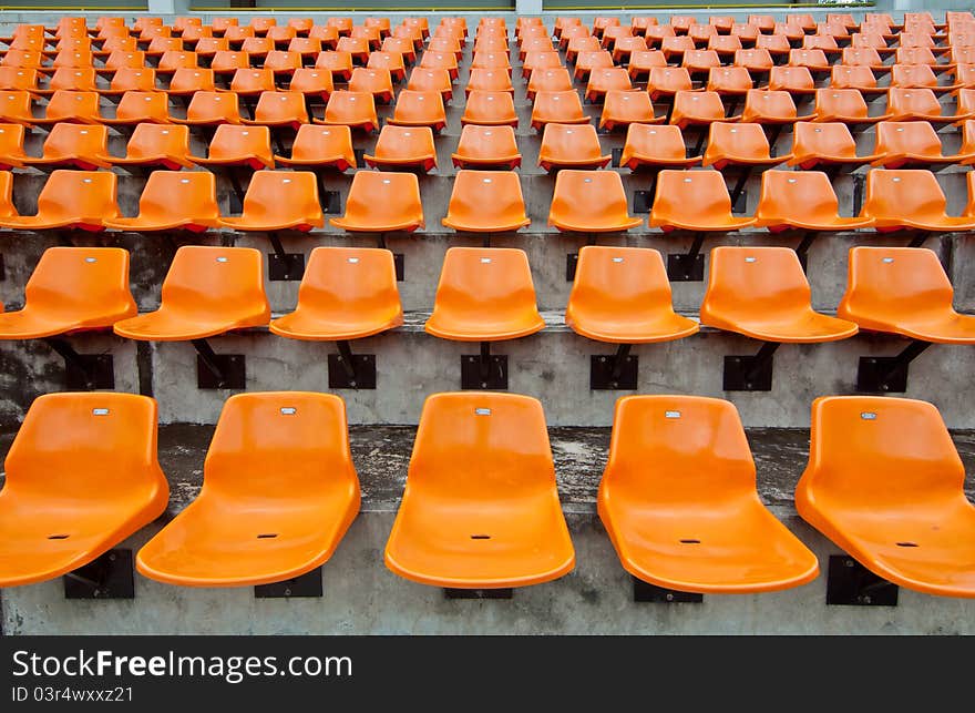 Front of the orange seats on the stadium