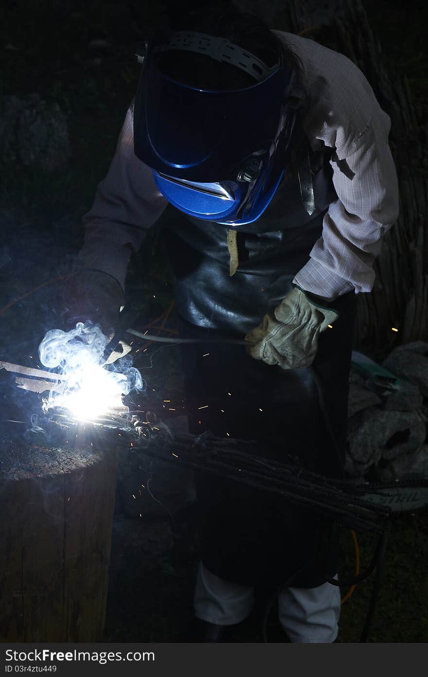 Welder woman in a mask doing the work