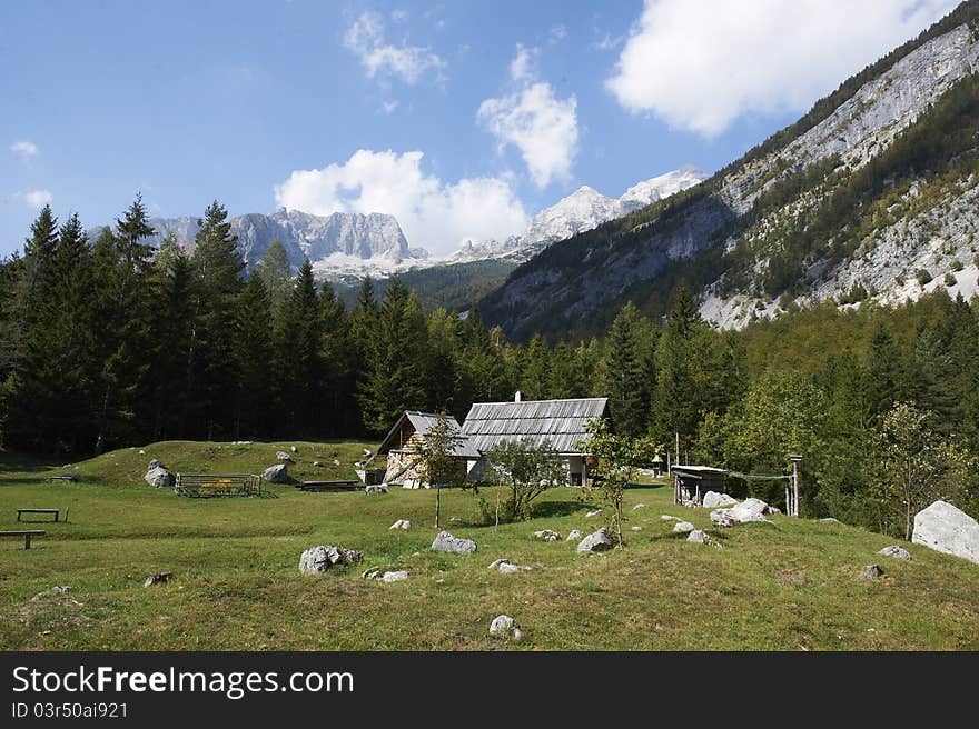 Alpine House, a high mountains meadow and blue sky. Alpine House, a high mountains meadow and blue sky