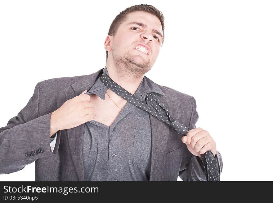 Young businessman pulling his tie and getting stressed. Young businessman pulling his tie and getting stressed