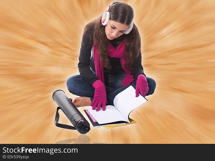 Beautiful young female student sitting on floor studying