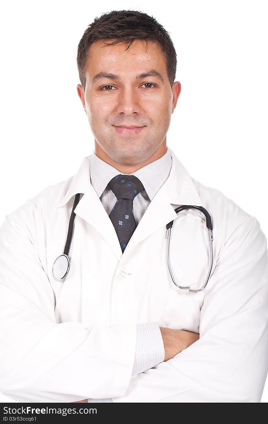 Young doctor standing with his arms crossed and smiling. Young doctor standing with his arms crossed and smiling