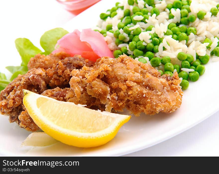 Chicken with rise served on white plate