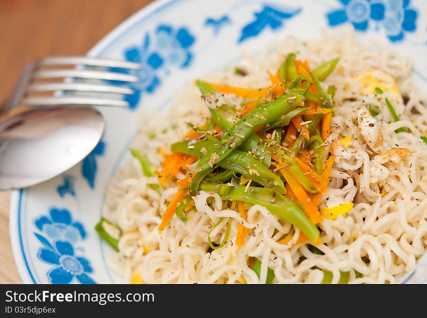 Macroshot of Chinese fried noodles with utensils. Macroshot of Chinese fried noodles with utensils.