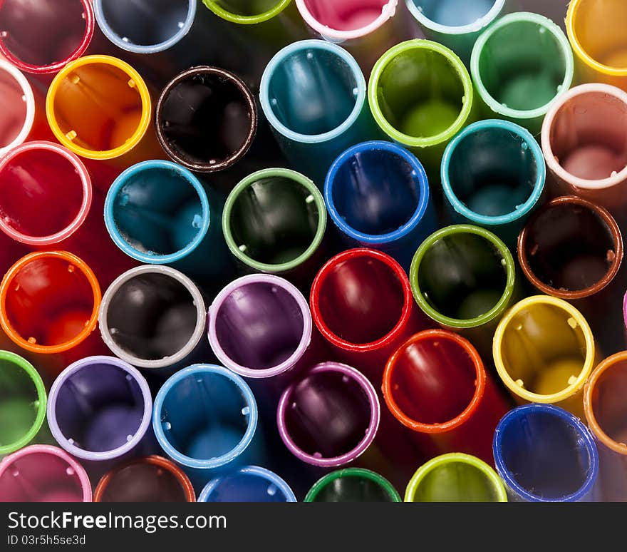 A closeup of pen caps with different colors. A closeup of pen caps with different colors