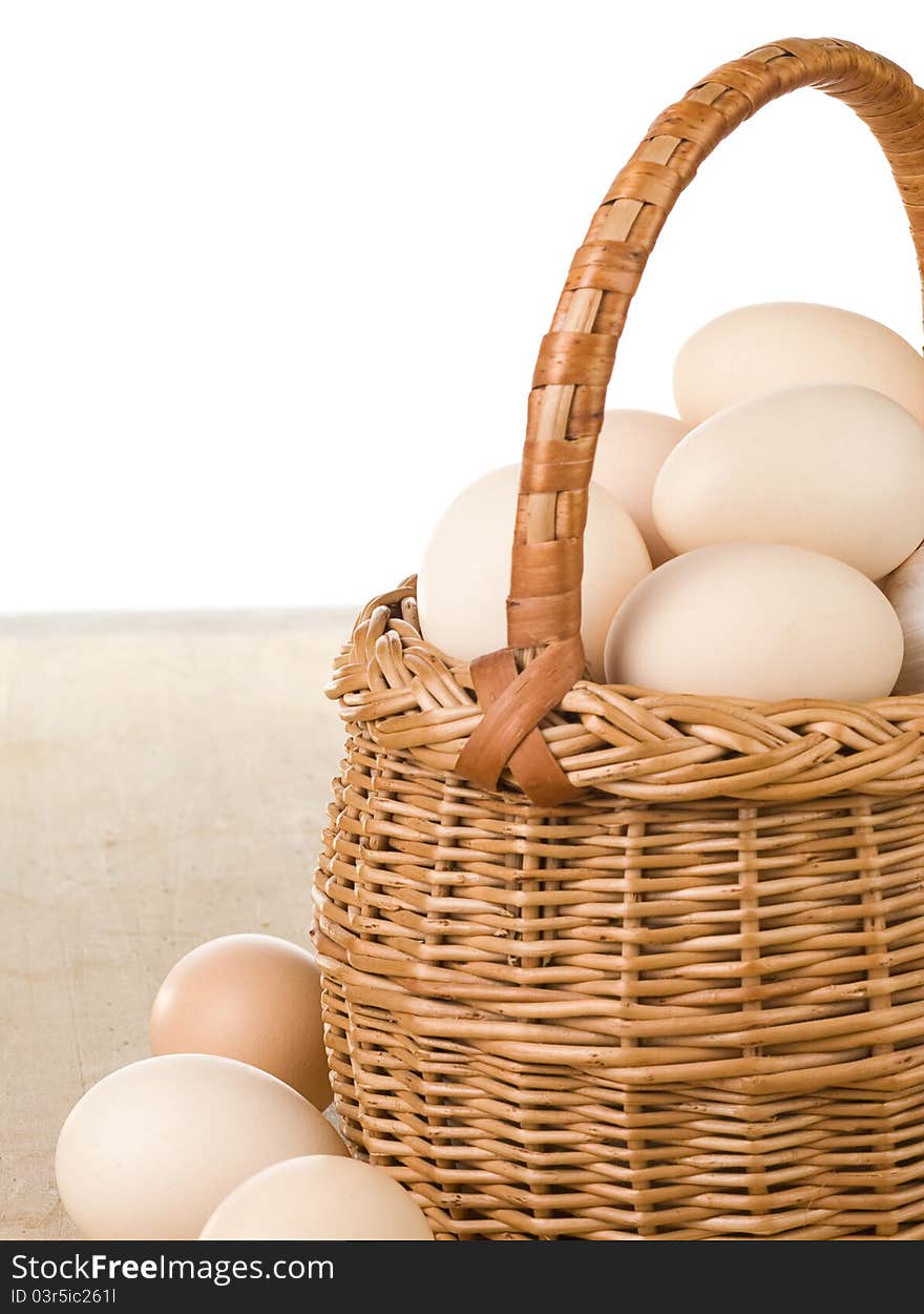 Eggs and basket on white background