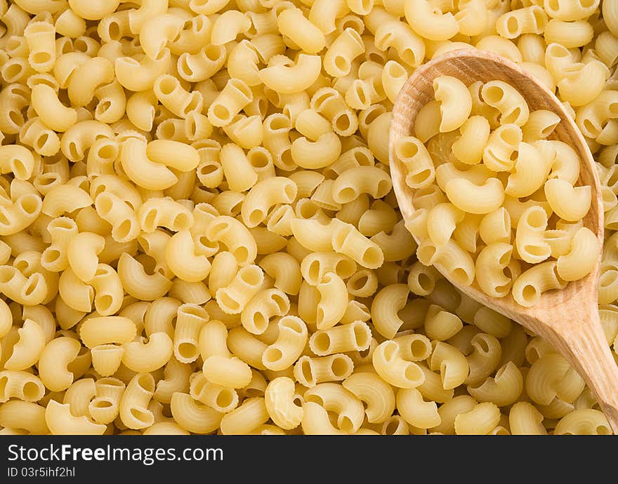 Pasta and wooden spoon as background