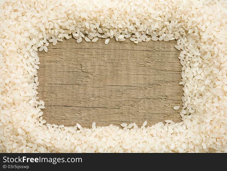 Rice grain on wood background texture