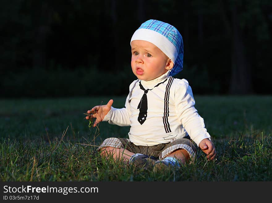 Baby boys sitting  in autumn park.