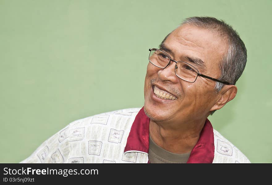 Laughing old man in green