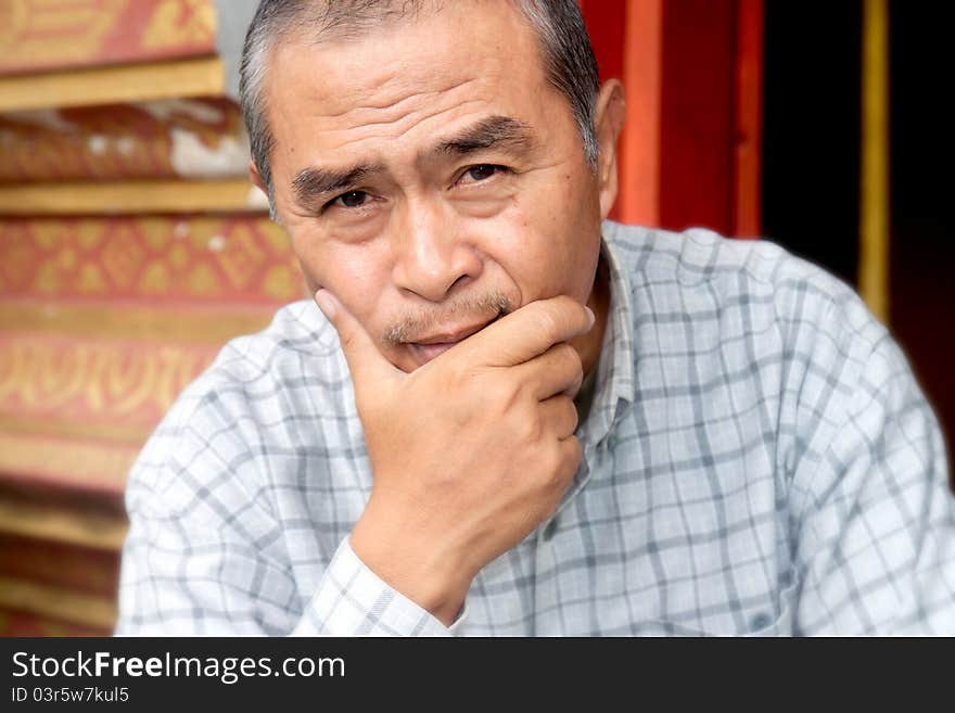 Portrait of smiling old man in temple