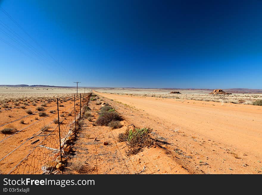 Road through a vast, arid landscape