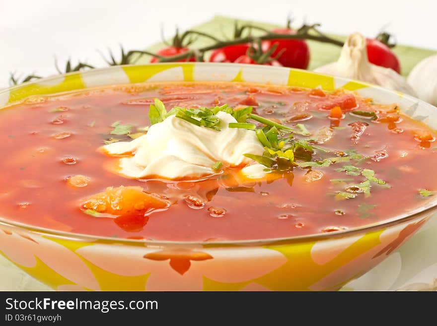 Fresh hot beet borscht with sour cream and herbs