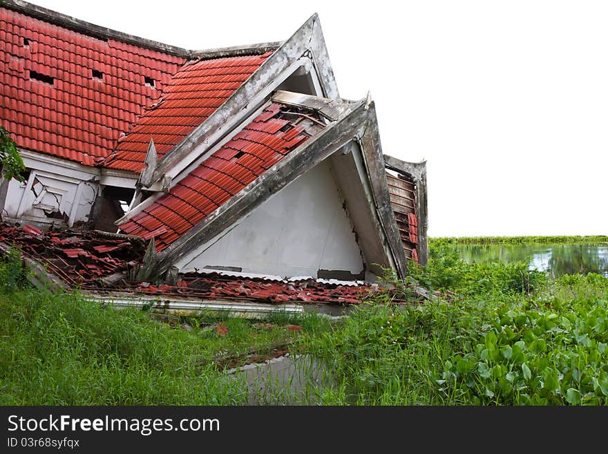 Ruins of the thai house has red roof broken down which is located pond side. Ruins of the thai house has red roof broken down which is located pond side.