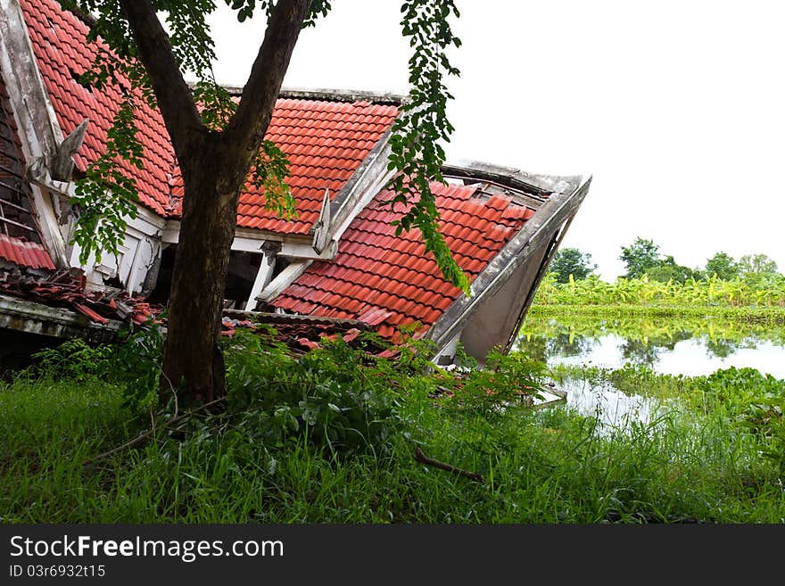 Ruins of the thai house has red roof broken down which is located pond side. Ruins of the thai house has red roof broken down which is located pond side.