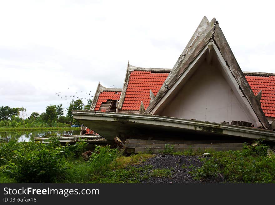 Ruins of the thai house has red roof broken down which is located pond side. Ruins of the thai house has red roof broken down which is located pond side.