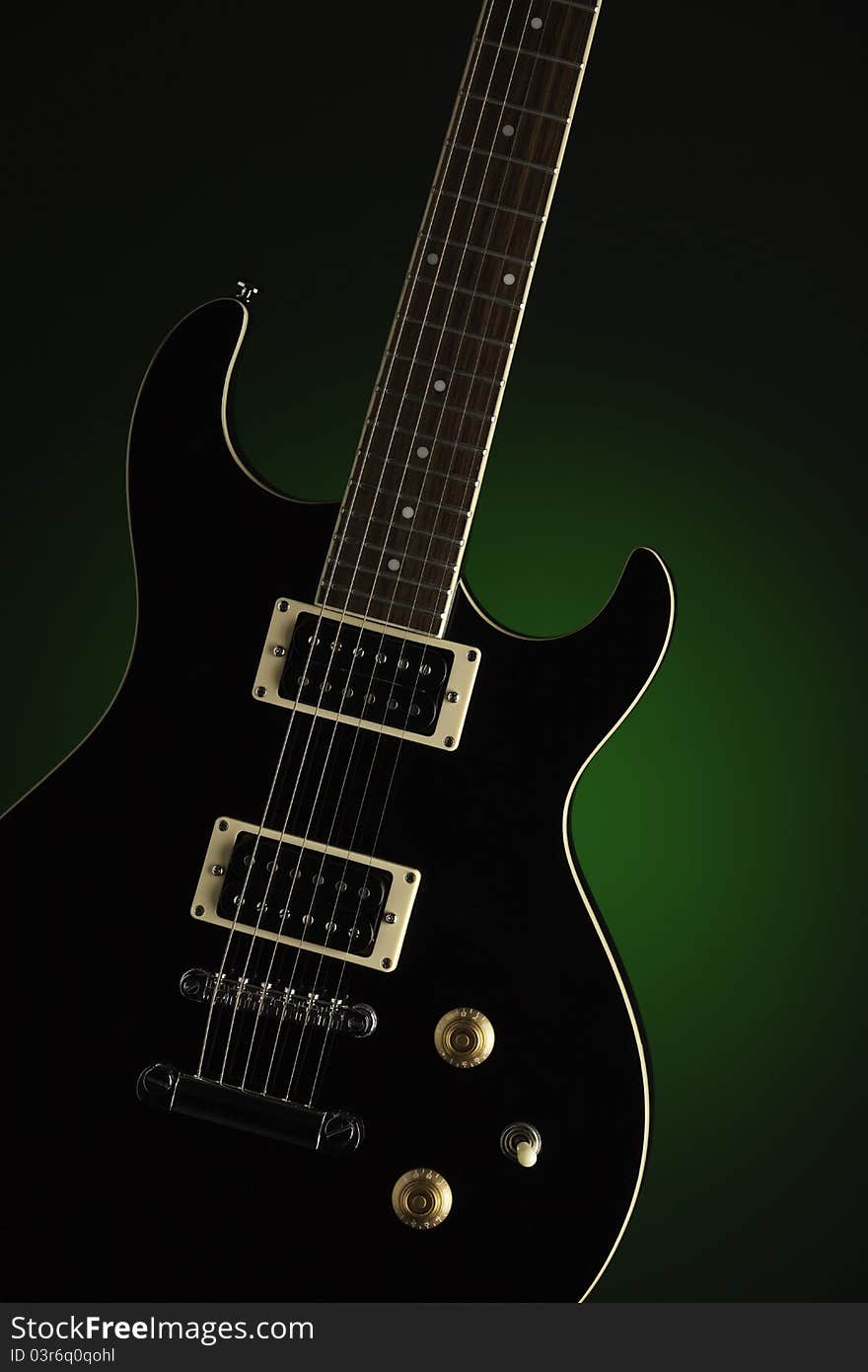 Black Electric Guitar On Green