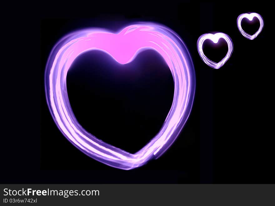 Image pink heart glow in the darkness