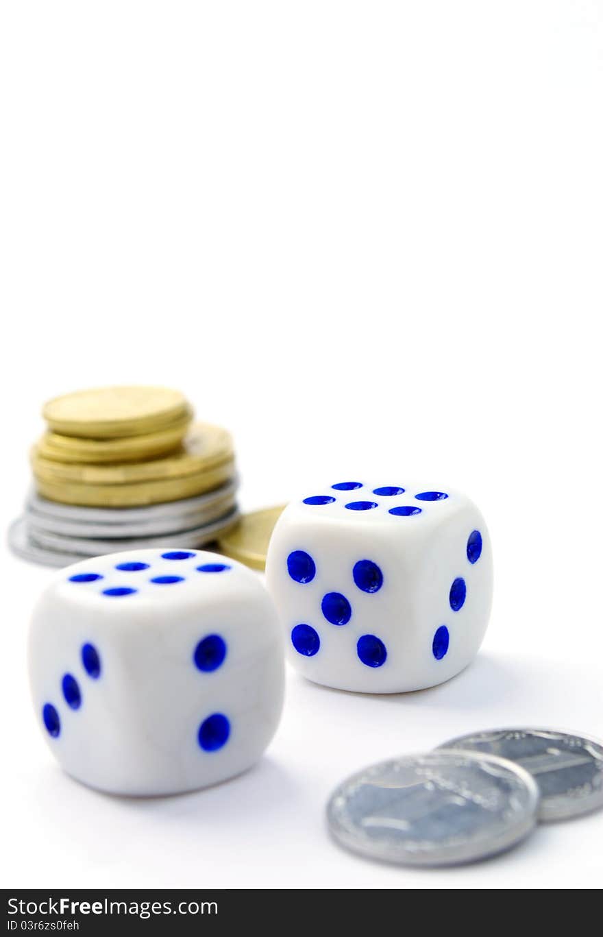 Dice and coins on a white background. Dice and coins on a white background