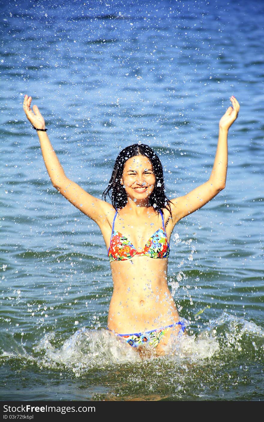 Young girl with black hair enjoys swimming. Young girl with black hair enjoys swimming