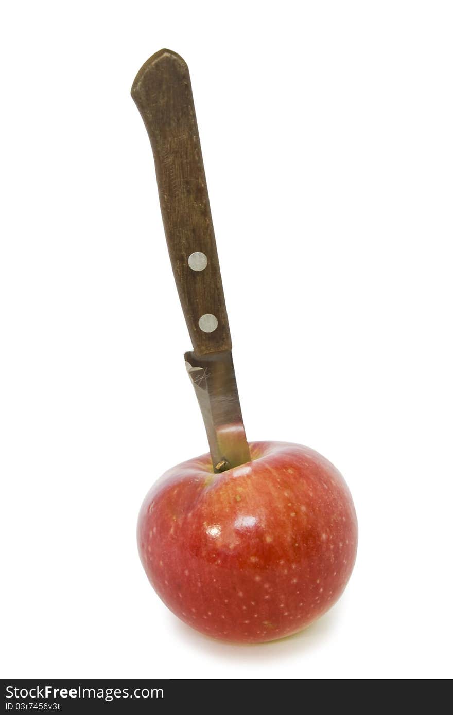 Knife in the apple on a white background