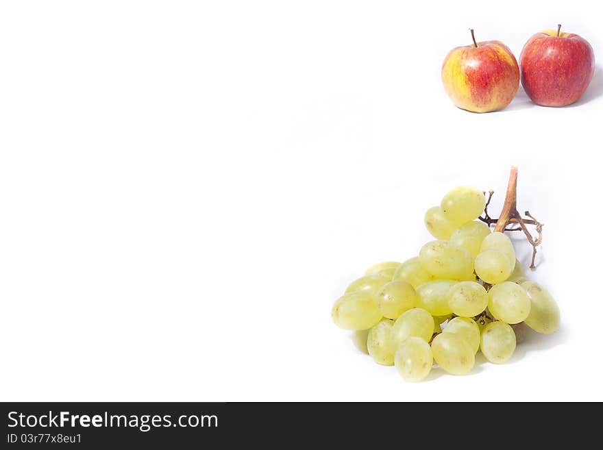 Apples and grapes on a white background. Apples and grapes on a white background