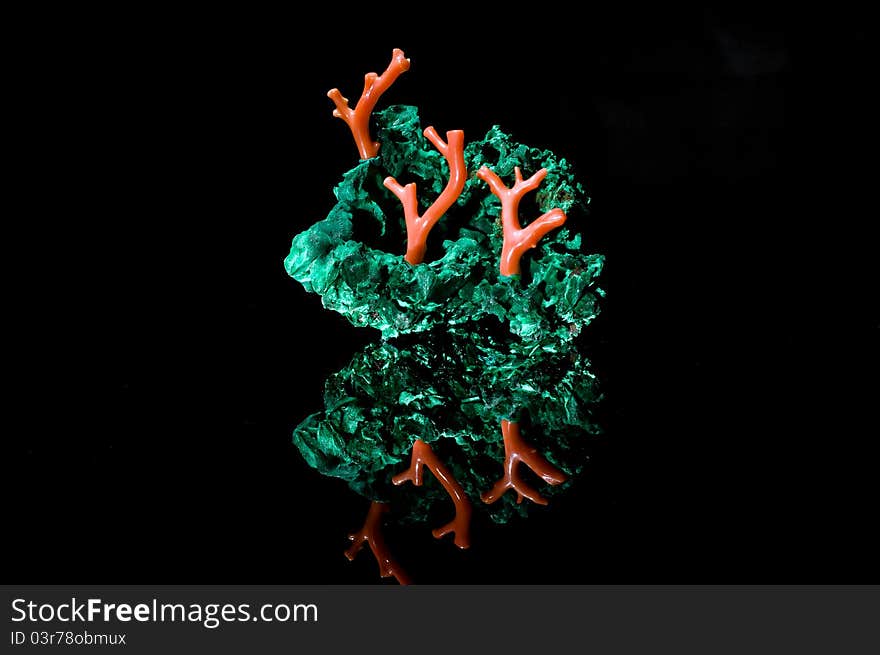 Malachite and coral jewerly compozition on black background