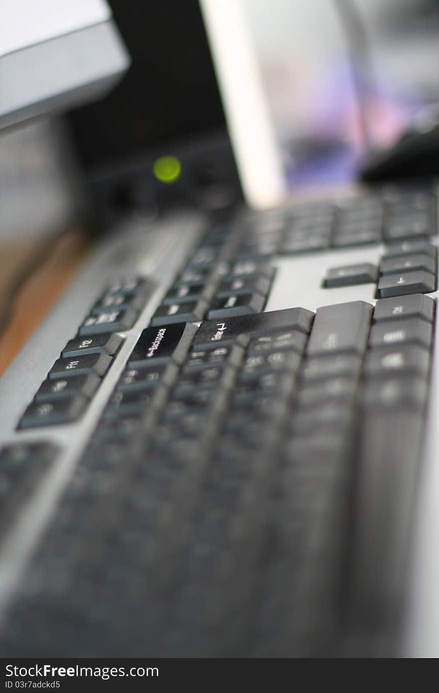 Keyboard and speakers on a table, just enter button in focus. Keyboard and speakers on a table, just enter button in focus