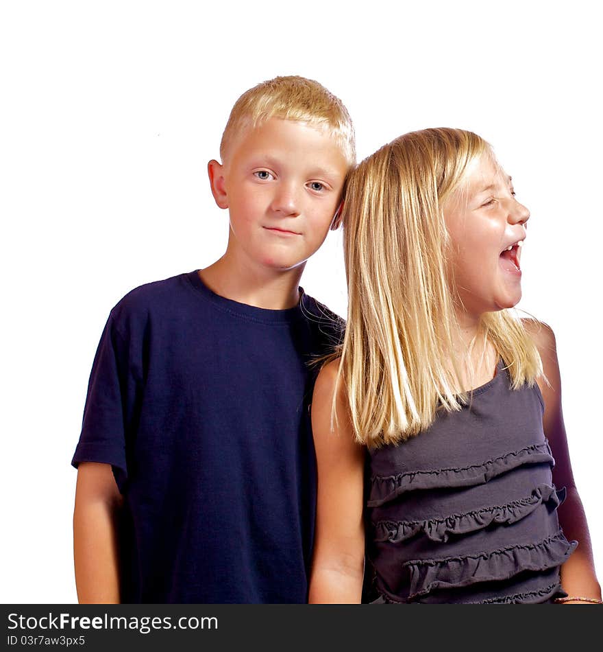 Young boy annoyed with his sister as she hysterically laughs. Young boy annoyed with his sister as she hysterically laughs.