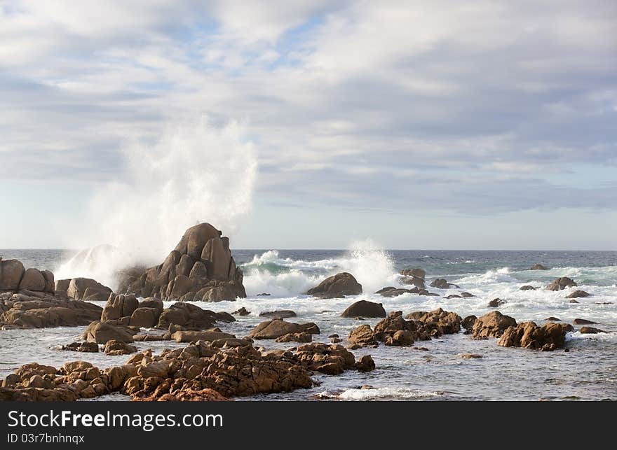 Sea rock is breaking powerful wave, splash