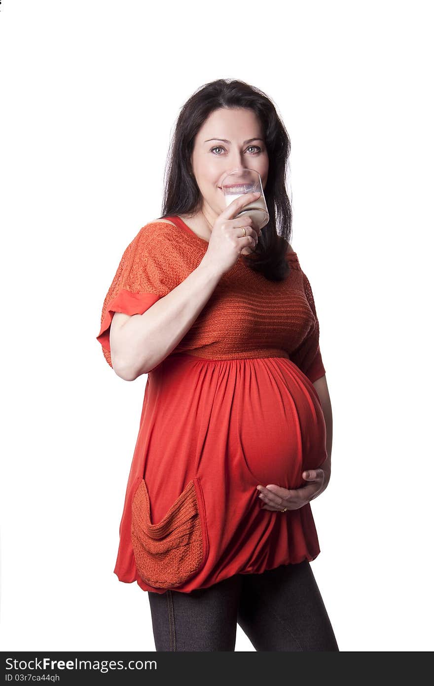 A pregnant woman drinks milk isolated on white