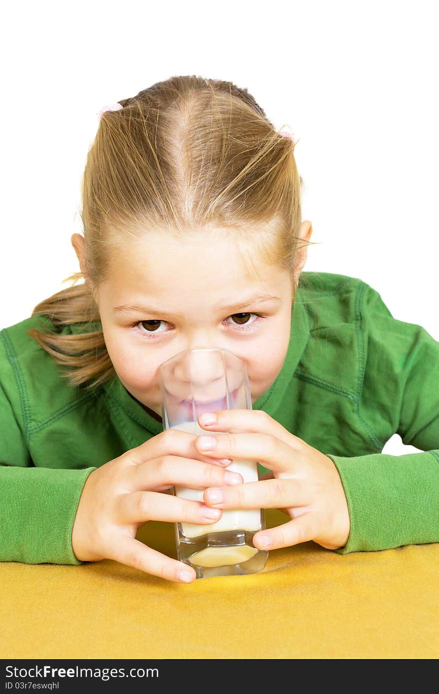 Happy little girl with a glass of milk, isolated over white