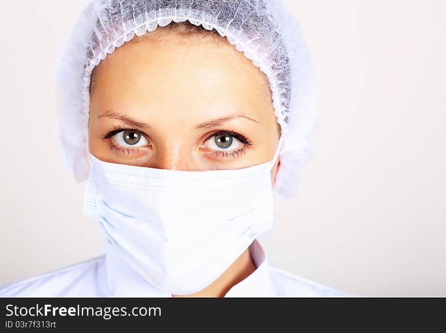 Young female scientist wearing face mask