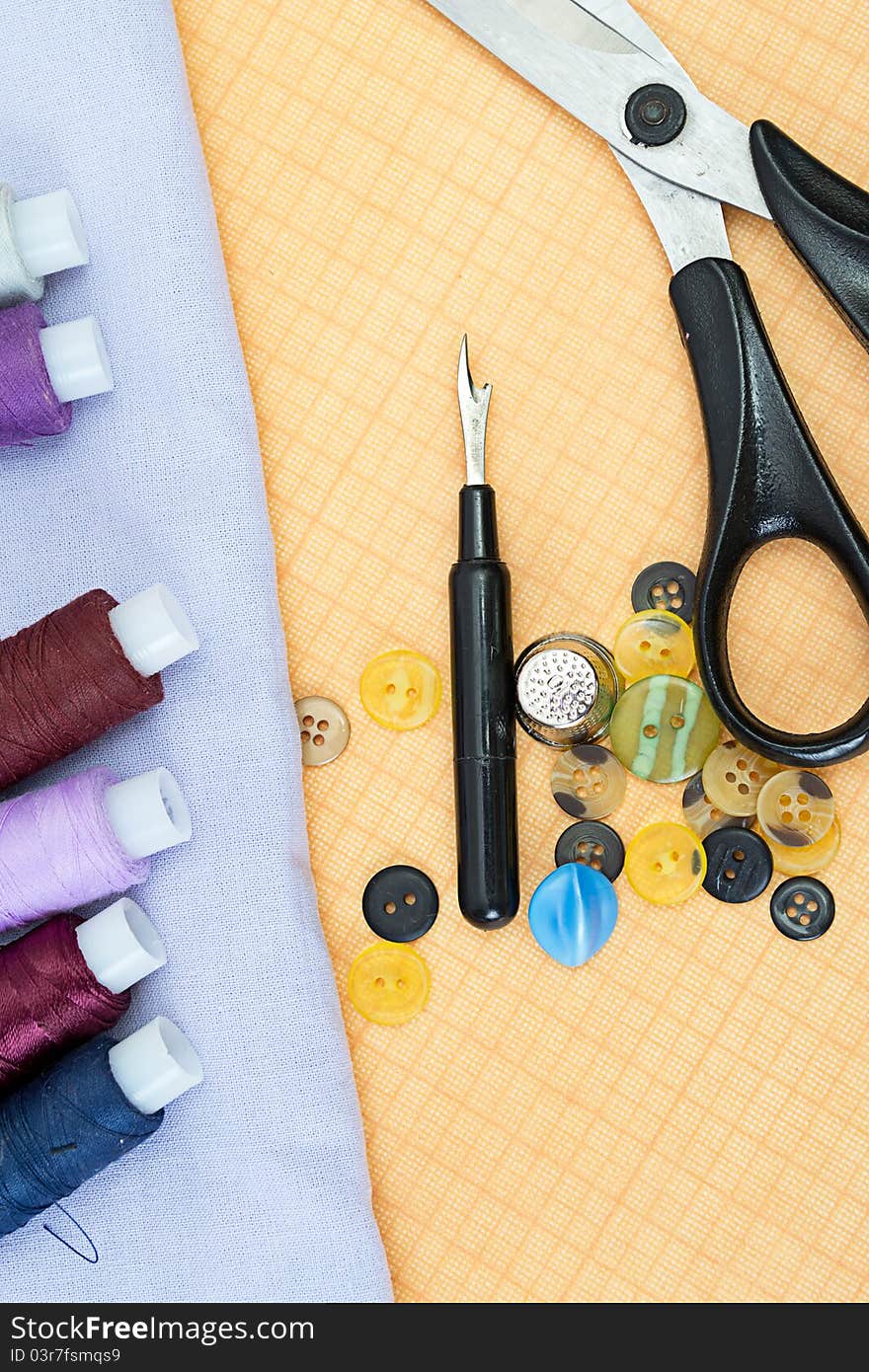 Sewing supplies: thread, scissors, buttons