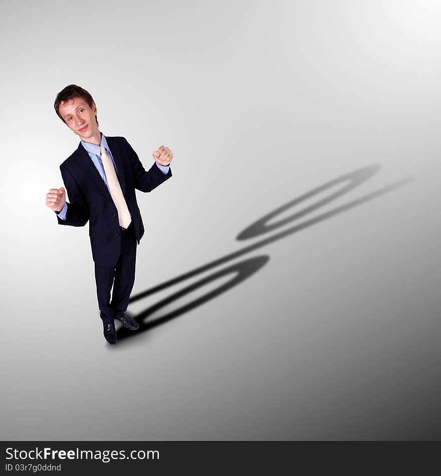 Image of a business man with a shadow shaped as a currency sign. Image of a business man with a shadow shaped as a currency sign