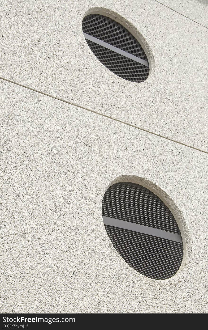 Two circles and two lines on exterior wall with texture. Two circles and two lines on exterior wall with texture